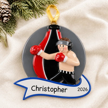 Personalized boxing guy christmas ornament laid on a soft white knit blanket