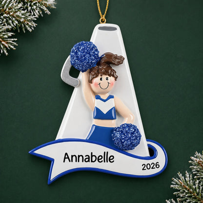Personalized cheerleader blue megaphone christmas ornament on a dark green pine background