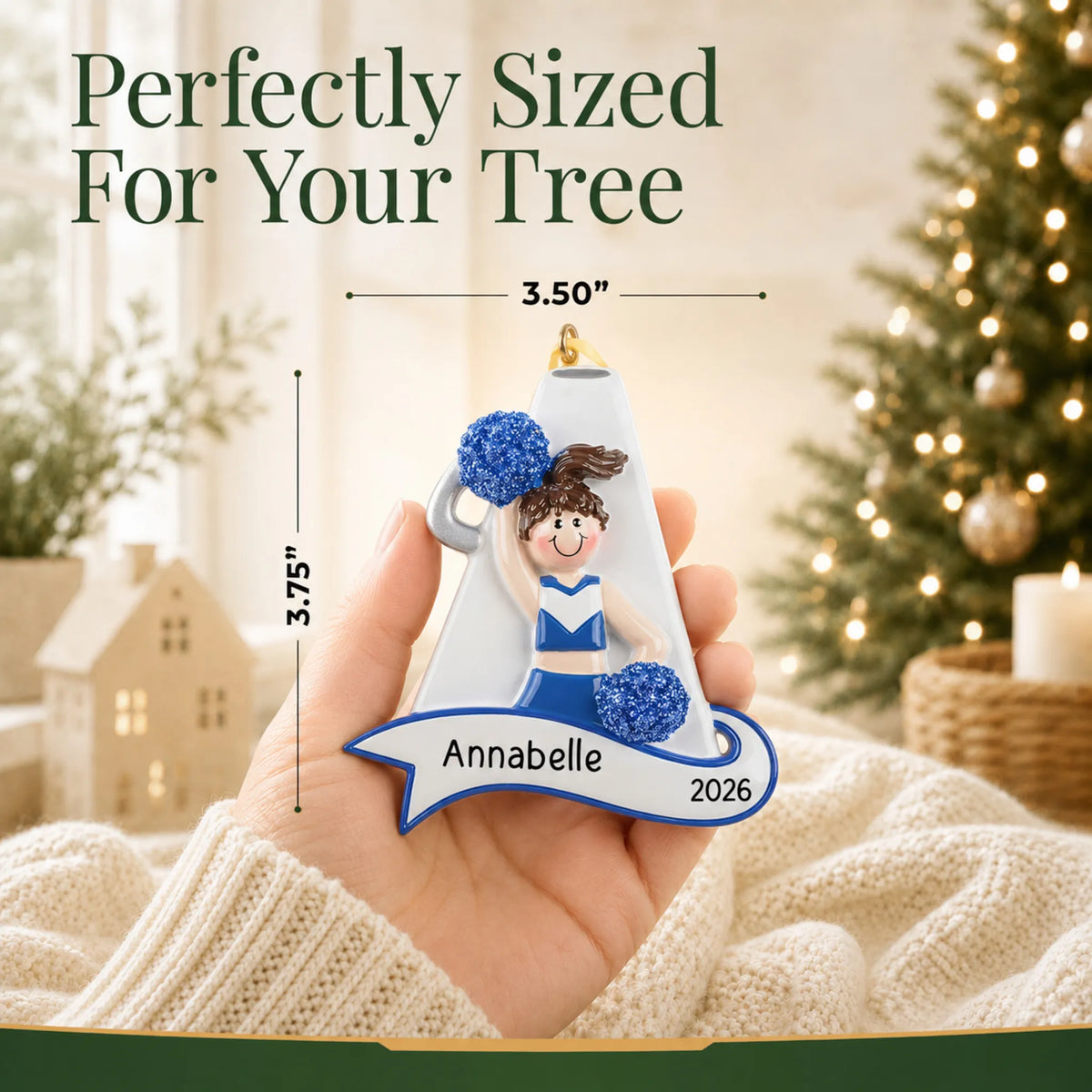Size guide: the personalized cheerleader blue megaphone christmas ornament is 3.50 in wide by 3.75 in tall, shown in hand