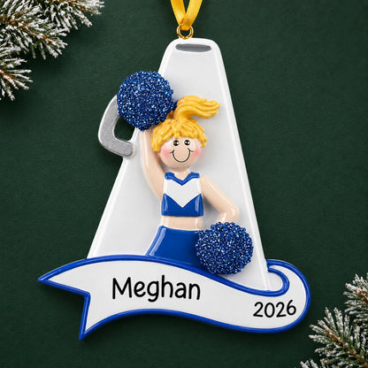 Personalized blonde cheerleader blue megaphone christmas ornament on a dark green pine background