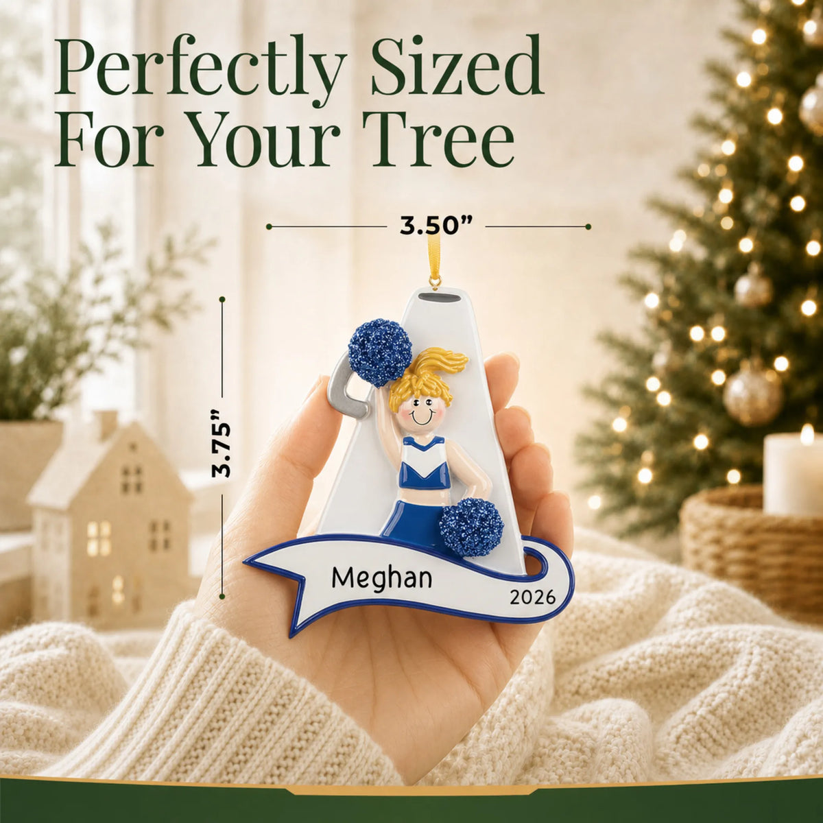 Size guide: the personalized blonde cheerleader blue megaphone christmas ornament shown in hand next to a Christmas tree