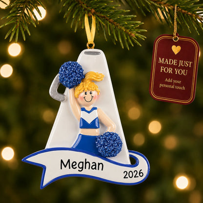 Blonde cheerleader blue megaphone christmas ornament hanging on a lit Christmas tree with a Made Just For You gift tag