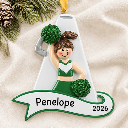 Personalized cheerleader green megaphone christmas ornament laid on a soft white knit blanket