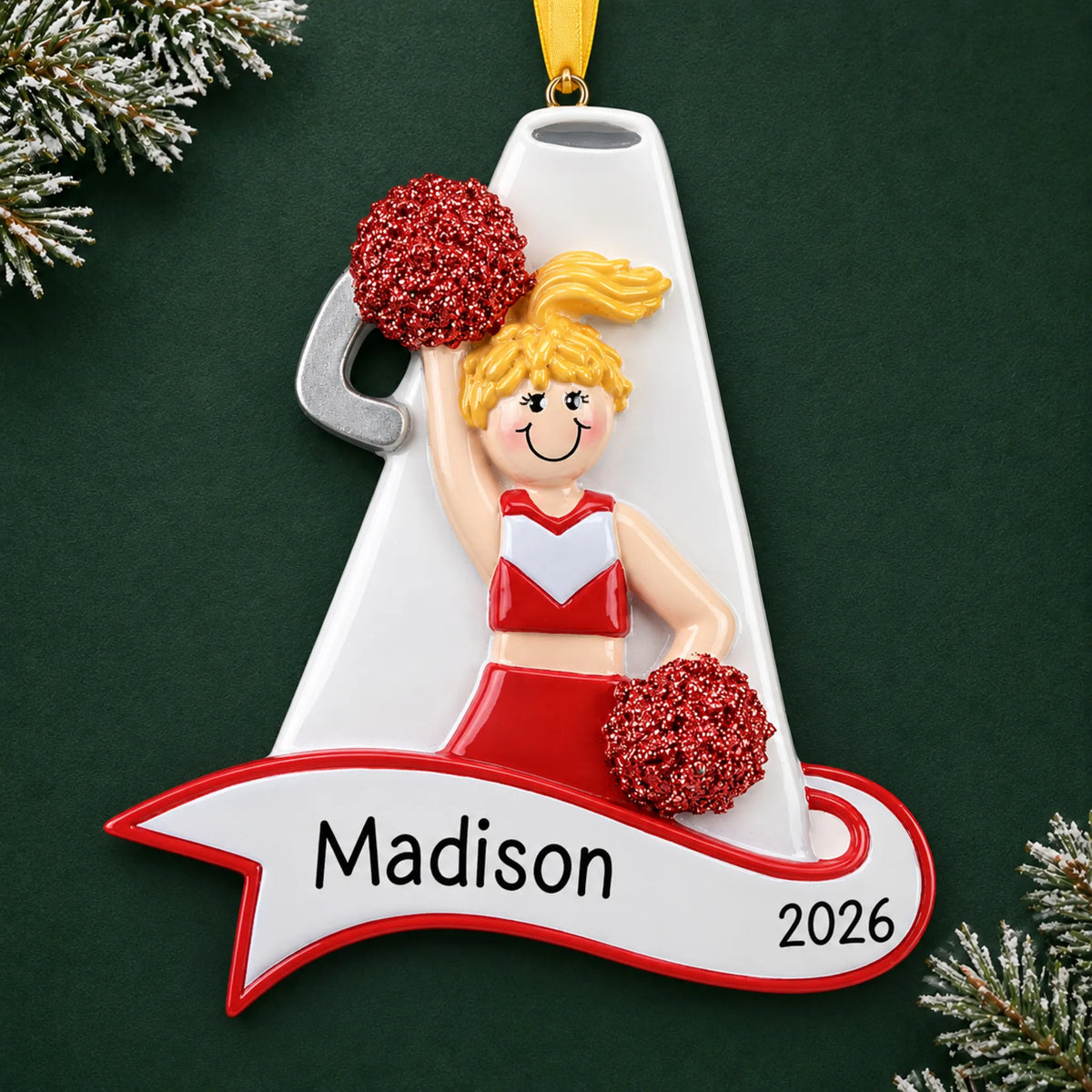 Personalized blonde cheerleader red megaphone christmas ornament on a dark green pine background