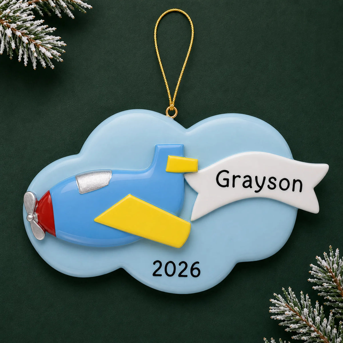 Personalized airplane christmas ornament on a dark green pine background