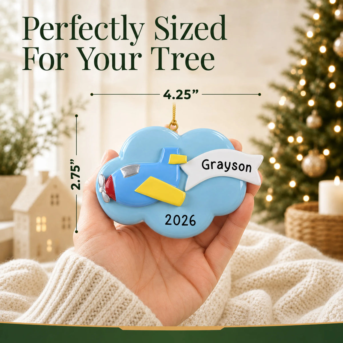Size guide: the personalized airplane christmas ornament is 4.25 in wide by 2.75 in tall, shown in hand