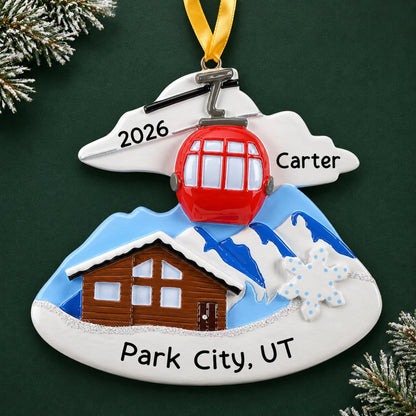 Personalized ski lodge christmas ornament on a dark green pine background