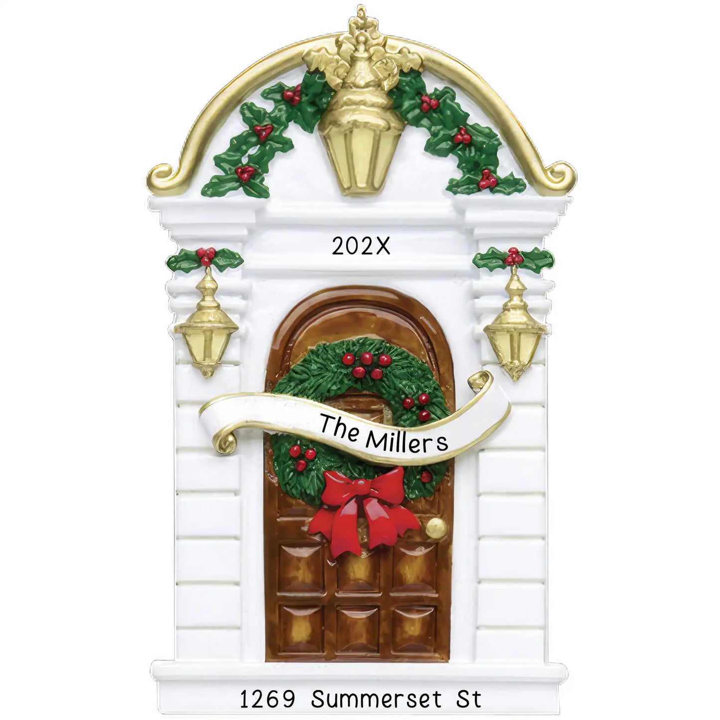 A personalized holiday ornament featuring a brown house door with a wreath, holly leaves, and a bow. The front door has 'The Millers' written on it, and the year 'Year' at the top.