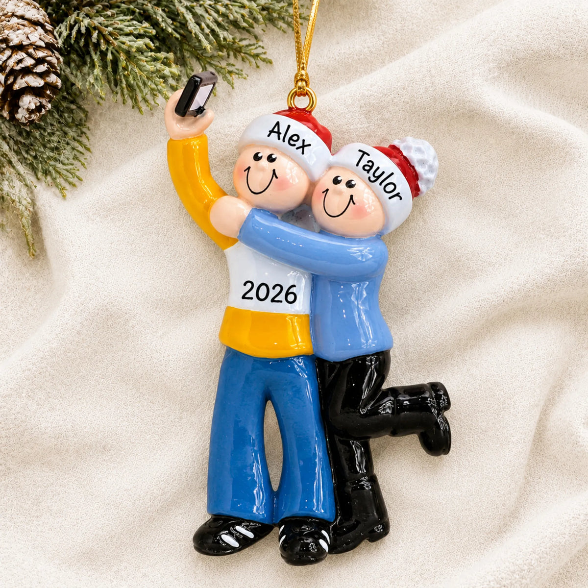 Personalized selfie couple christmas ornament laid on a soft white knit blanket