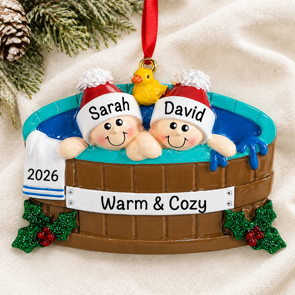 Personalized hot tub couple christmas ornament laid on a soft white knit blanket