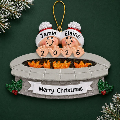 Personalized fire pit couple christmas ornament on a dark green pine background