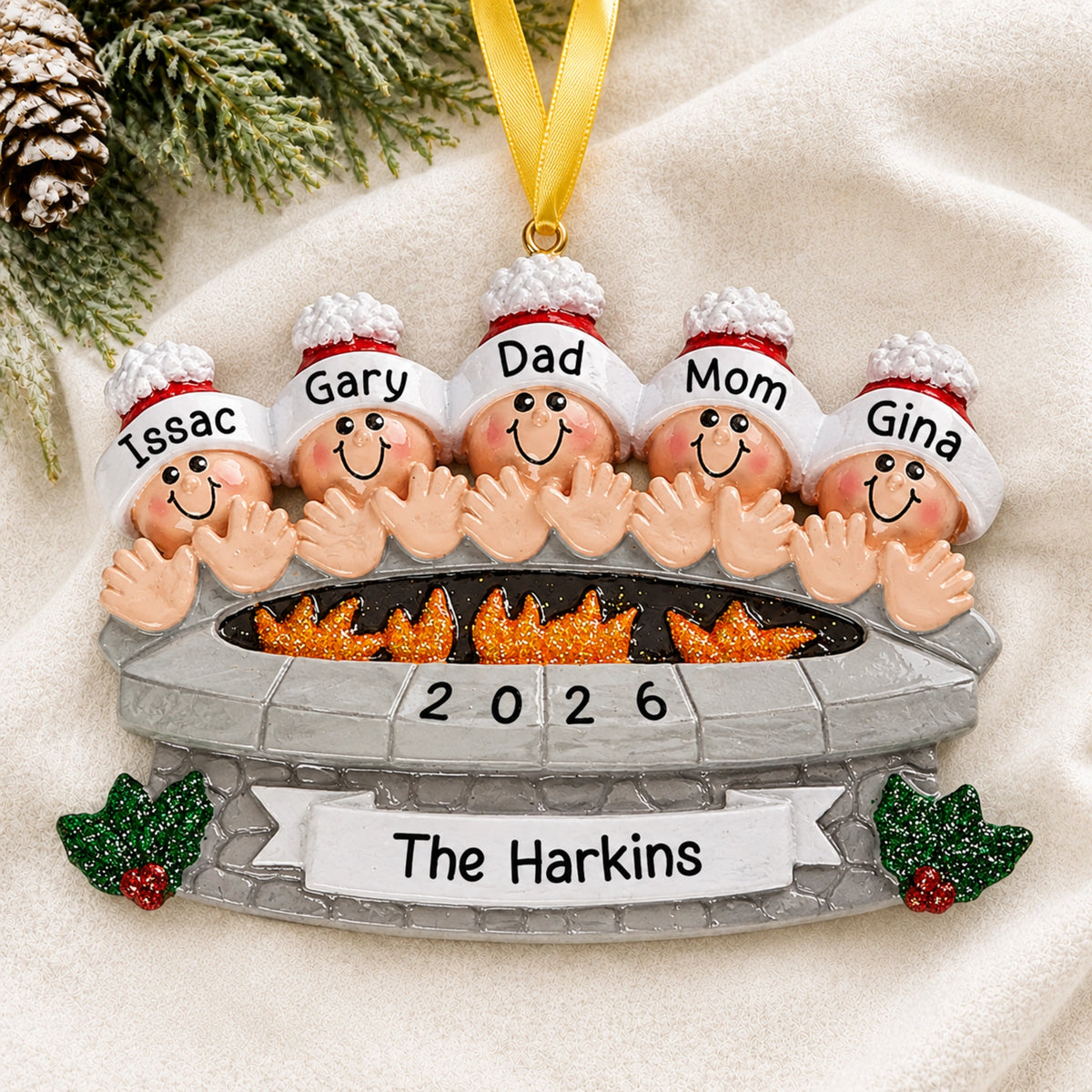Personalized fire pit family of 5 christmas ornament with names hanging on a snowy white background