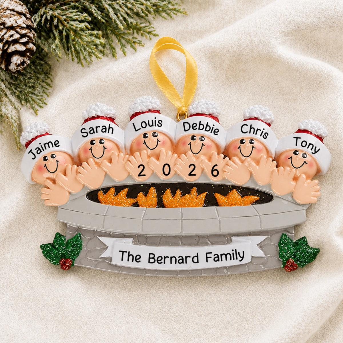Personalized fire pit family of 6 christmas ornament with names hanging on a snowy white background