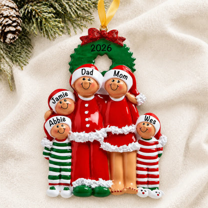 Personalized ethnic family of 5 christmas ornament laid on a soft white knit blanket