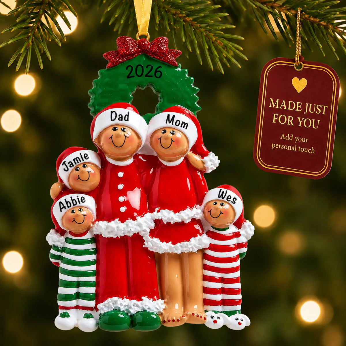 Ethnic family of 5 christmas ornament hanging on a lit Christmas tree with a Made Just For You gift tag