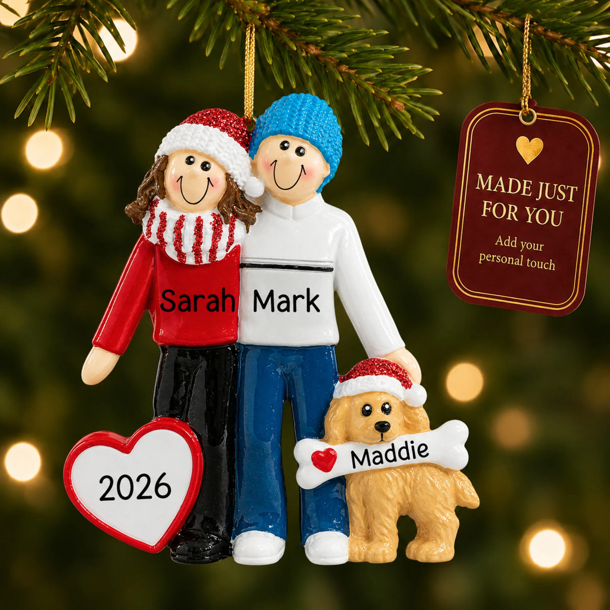 Winter couple with dog christmas ornament hanging on a lit Christmas tree with a Made Just For You gift tag