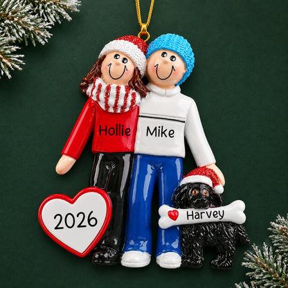 Personalized winter couple with black dog christmas ornament on a dark green pine background