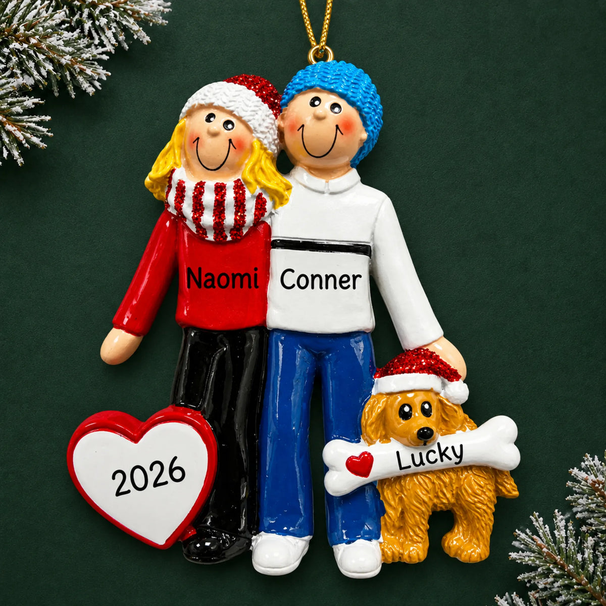 Personalized blonde couple with dog christmas ornament on a dark green pine background
