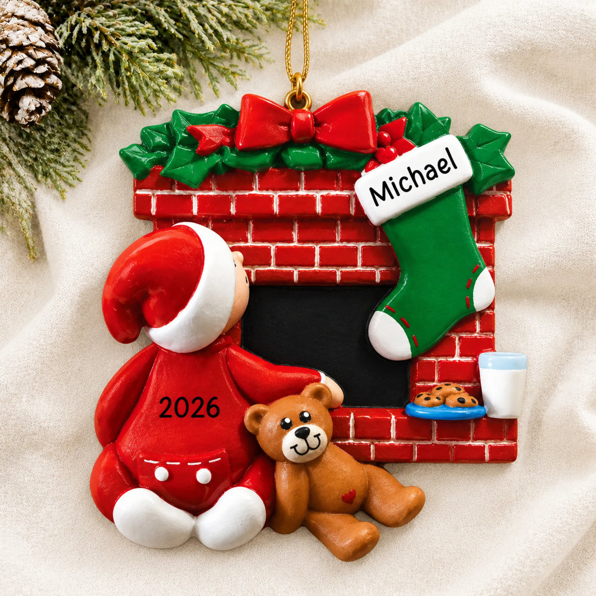 Personalized Waiting for Santa christmas ornament laid on a soft white knit blanket