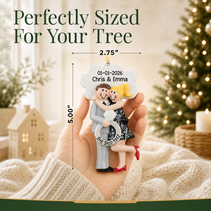 Personalized She Said Yes blonde couple Christmas ornament held in a hand to show its 2.75 by 5 inch size