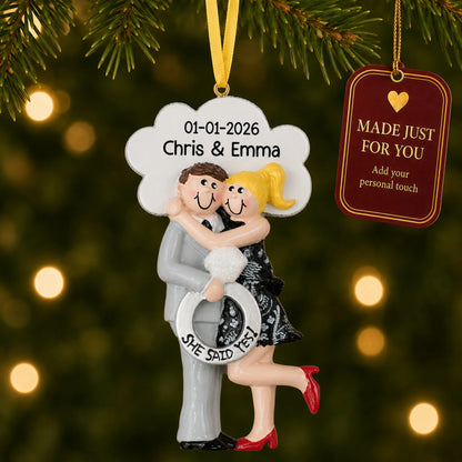 Personalized She Said Yes blonde couple Christmas ornament on a lit Christmas tree with a Made Just For You tag
