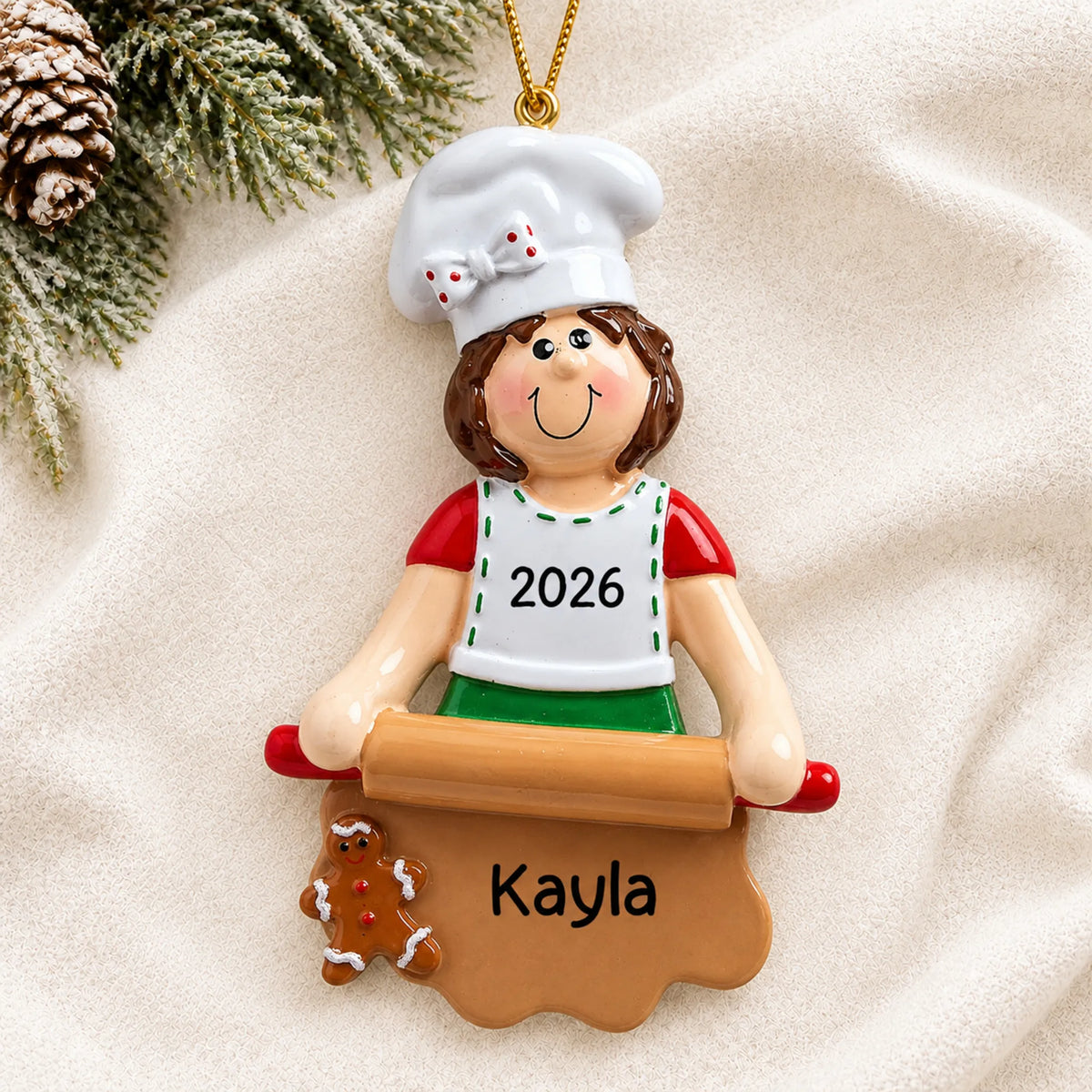 Personalized baking christmas ornament laid on a soft white knit blanket