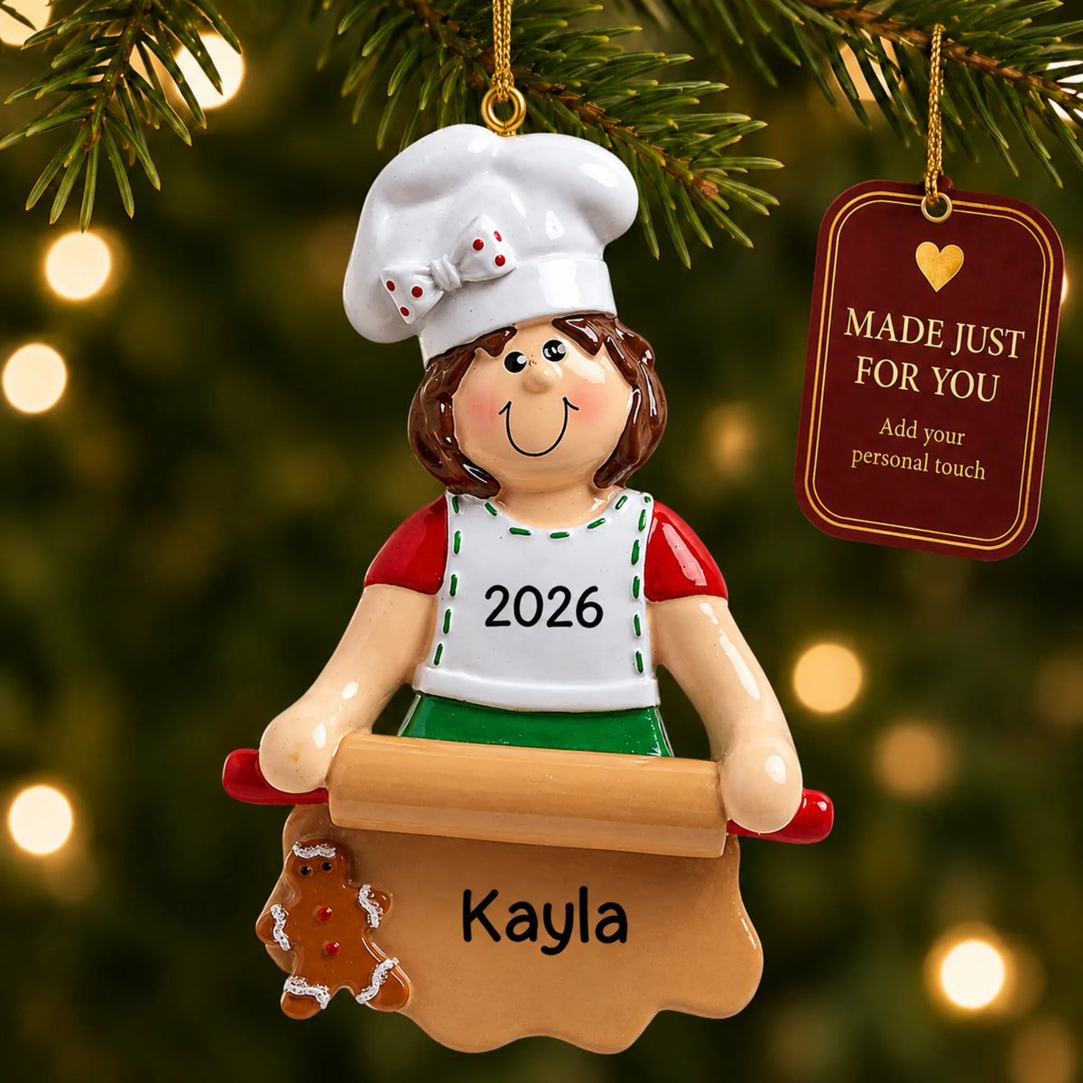 Baking christmas ornament hanging on a lit Christmas tree with a Made Just For You gift tag