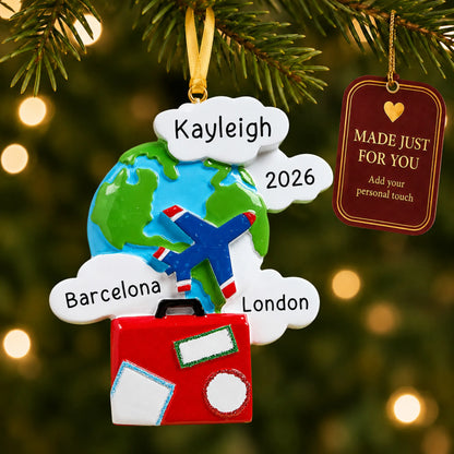 World traveler christmas ornament hanging on a lit Christmas tree with a Made Just For You gift tag