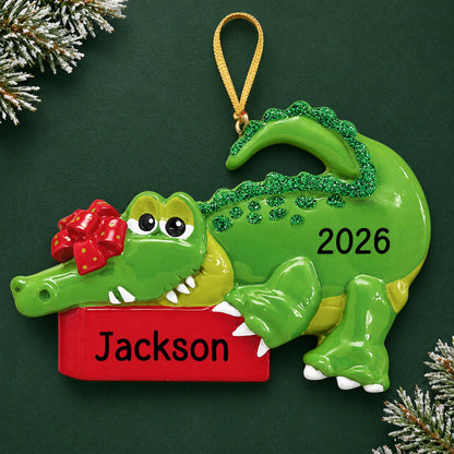 Personalized alligator christmas ornament on a dark green pine background