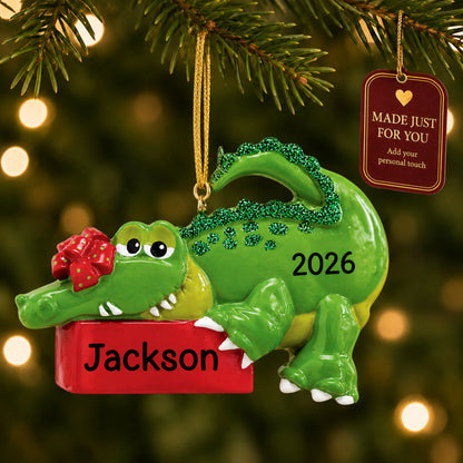 Alligator christmas ornament hanging on a lit Christmas tree with a Made Just For You gift tag