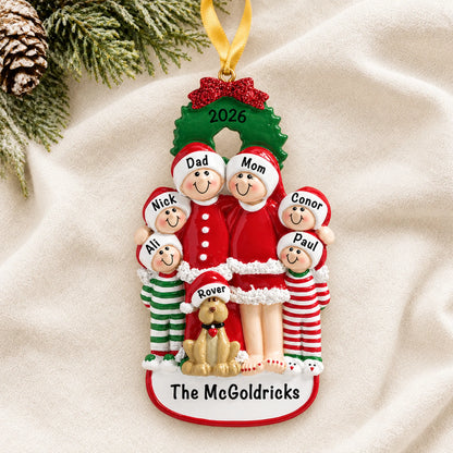 Personalized family of 6 with dog christmas ornament laid on a soft white knit blanket