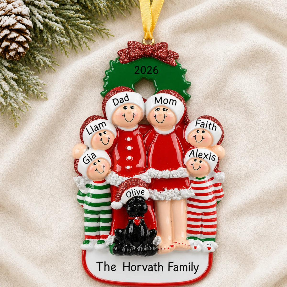 Personalized family of 6 with black dog christmas ornament laid on a soft white knit blanket