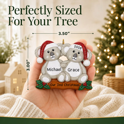 Size guide: the personalized koala couple christmas ornament is 3.50 in wide by 3.00 in tall, shown in hand