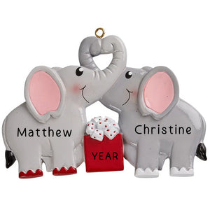 Personalized elephant couple ornament with trunks in a heart, laser engraved with names and year