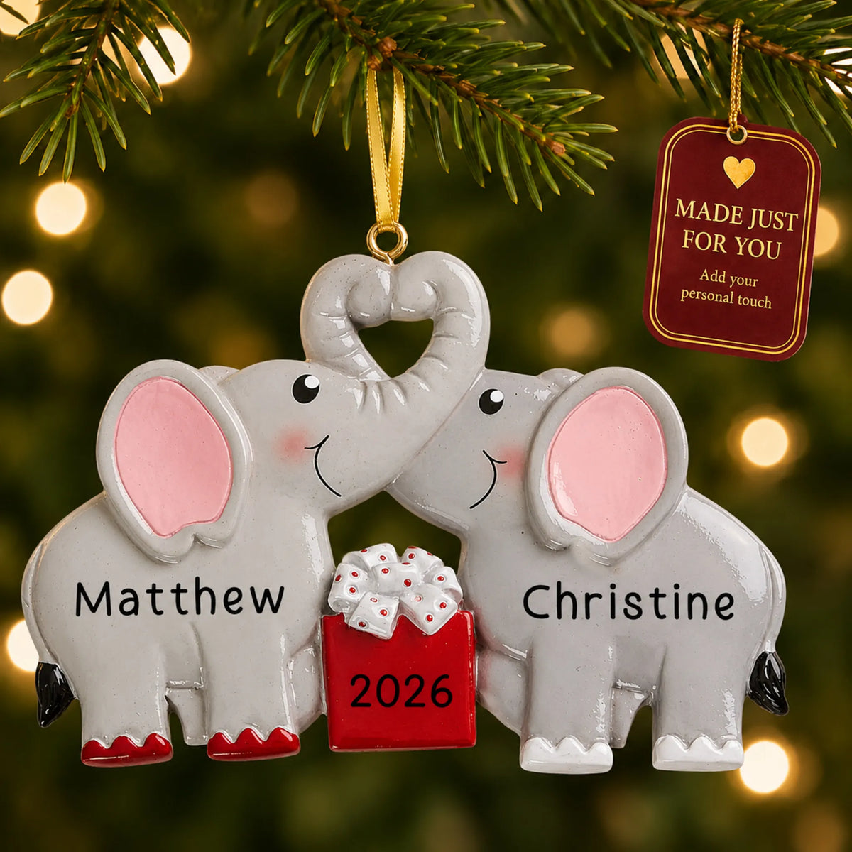 Elephant love couple christmas ornament hanging on a lit Christmas tree with a Made Just For You gift tag
