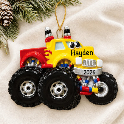 Personalized monster truck kids christmas ornament laid on a soft white knit blanket