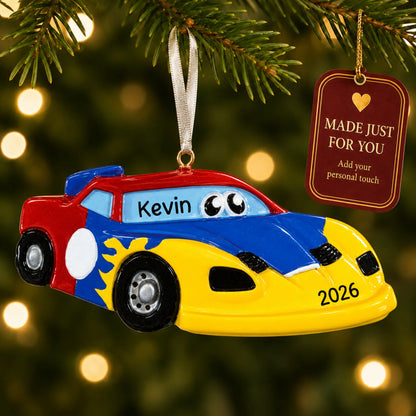 Race car christmas ornament hanging on a lit Christmas tree with a Made Just For You gift tag