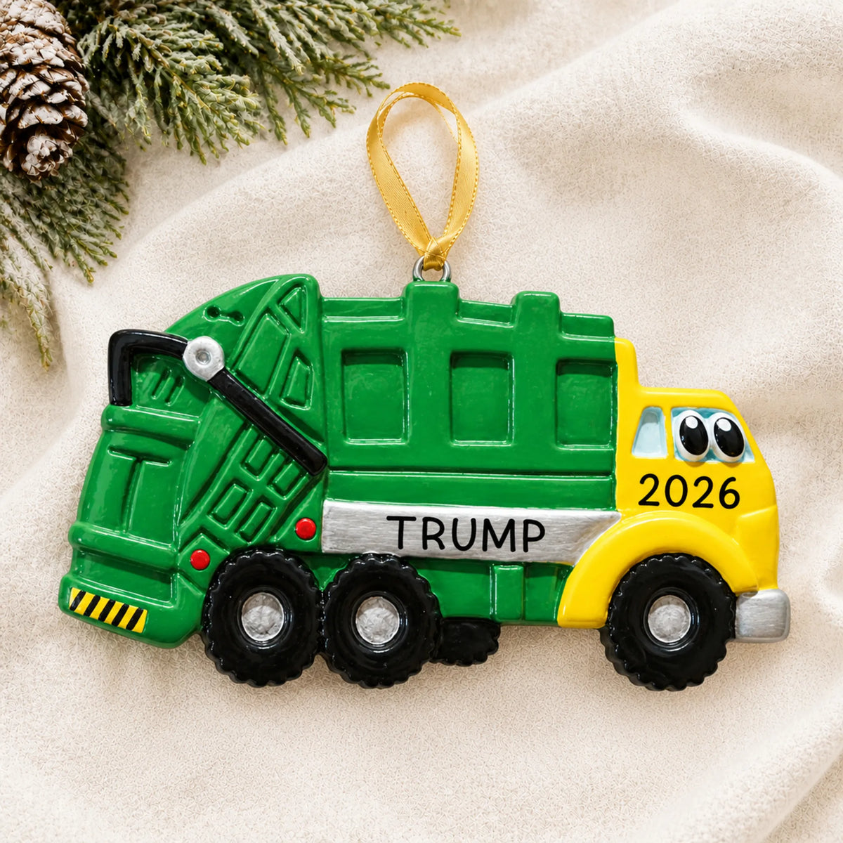 Personalized garbage truck kids christmas ornament laid on a soft white knit blanket
