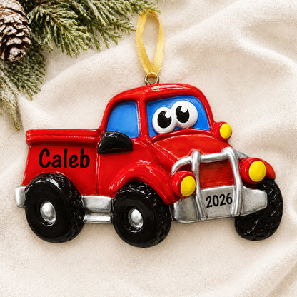 Personalized pickup truck christmas ornament laid on a soft white knit blanket