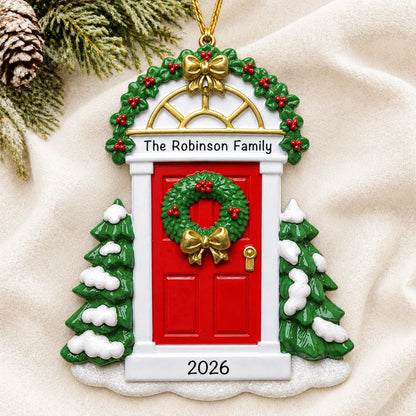 Personalized Red Door christmas ornament laid on a soft white knit blanket