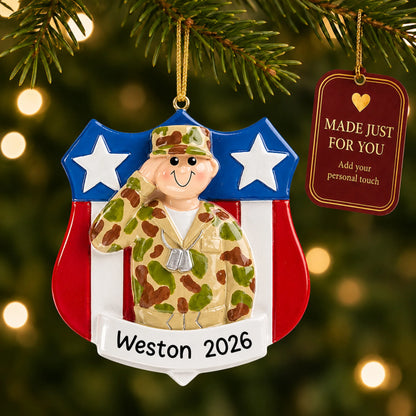 Personalized Army soldier USA shield Christmas ornament hanging among tree lights with a Made Just For You tag