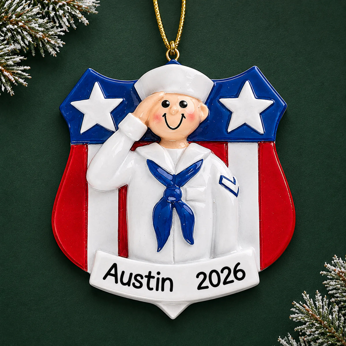 Personalized Navy sailor USA shield Christmas ornament with name and year, shown on a green holiday background