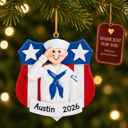 Personalized Navy sailor USA shield Christmas ornament hanging among tree lights with a Made Just For You tag
