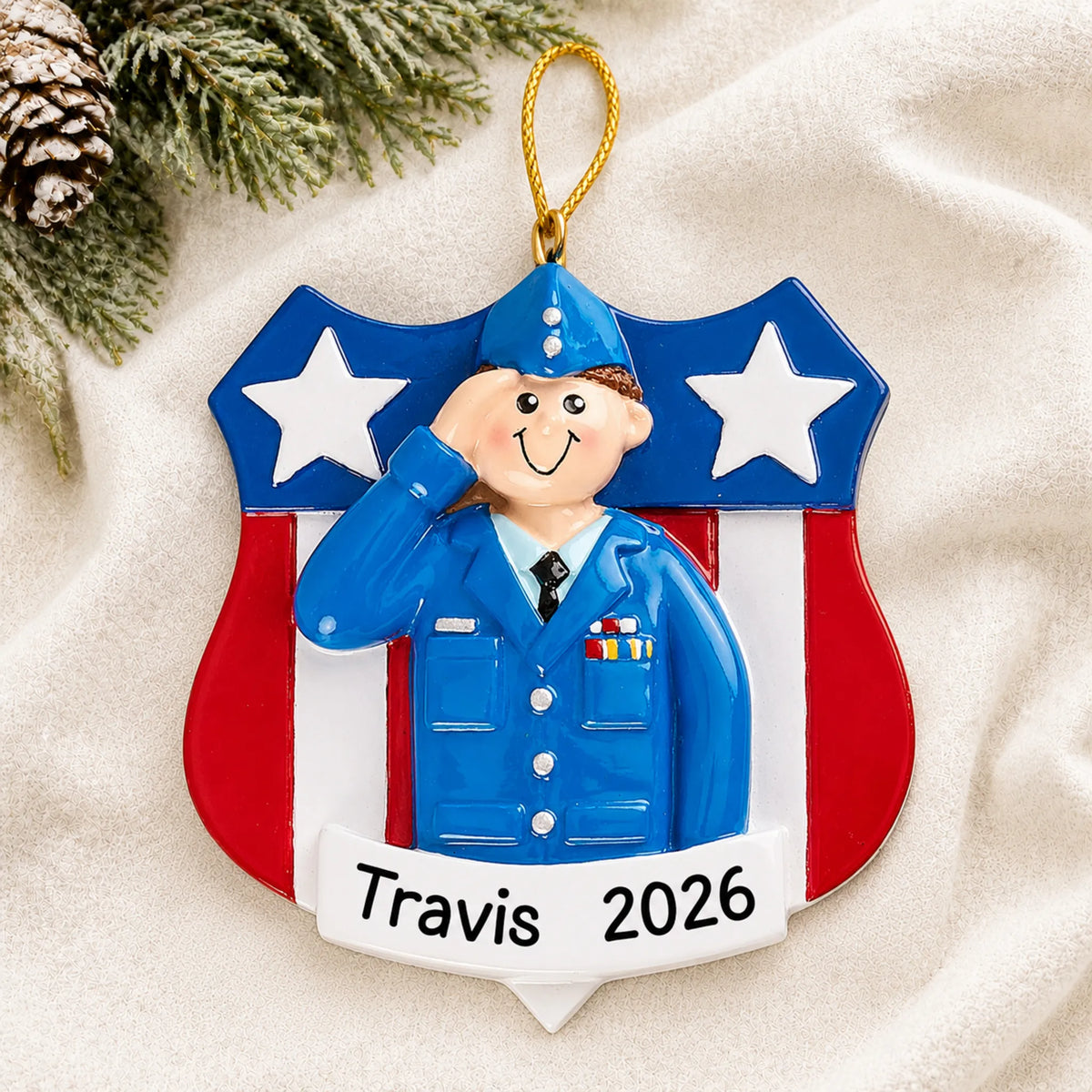 Personalized Air Force service member Christmas ornament shown on a soft white blanket