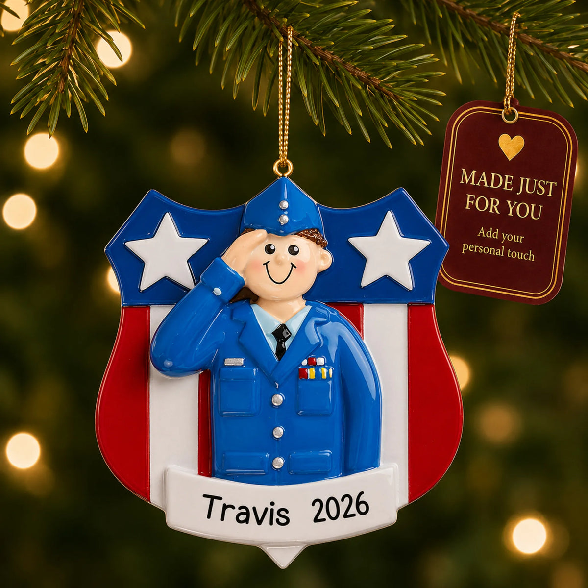 Personalized Air Force service member Christmas ornament hanging among tree lights with a Made Just For You tag