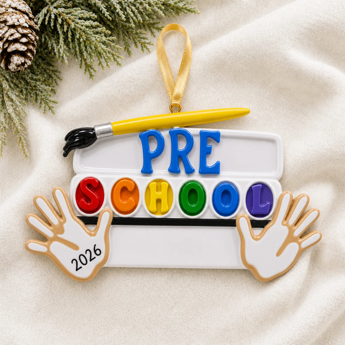 Personalized preschool Christmas ornament shown on a soft white blanket