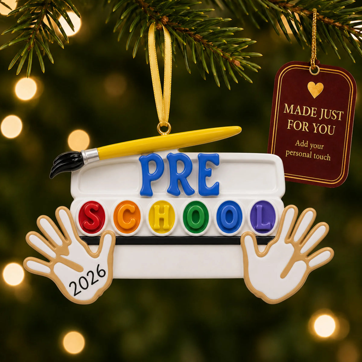 Personalized preschool Christmas ornament hanging among tree lights with a Made Just For You tag