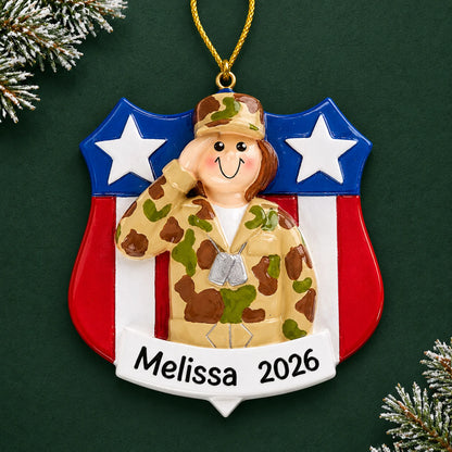 Personalized female Army soldier Christmas ornament with name and year, shown on a green holiday background