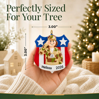 Personalized female Army soldier Christmas ornament held in hand to show its size on the tree