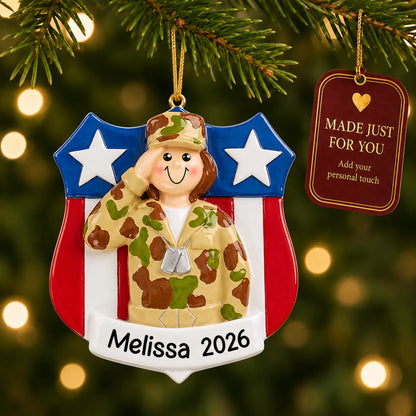 Personalized female Army soldier Christmas ornament hanging among tree lights with a Made Just For You tag